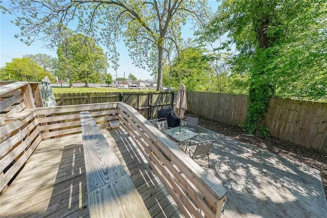 wooden deck with a fenced backyard
