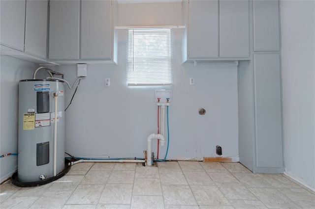 laundry room with cabinets and electric water heater