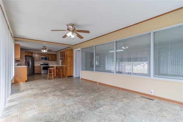 unfurnished living room with ceiling fan and crown molding