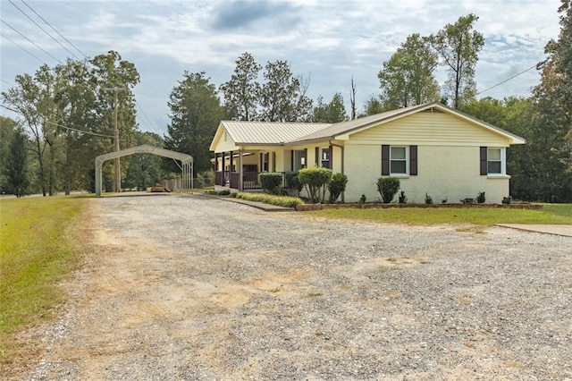 single story home with covered porch and a carport