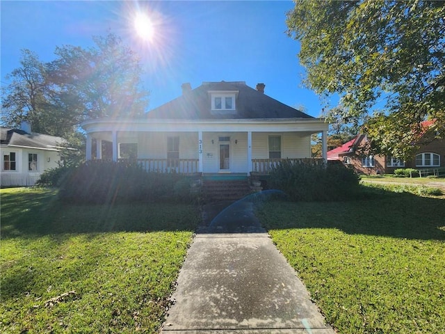 bungalow with a front lawn and covered porch