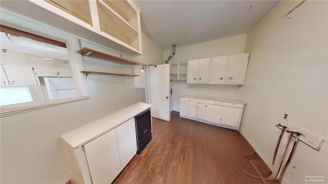 kitchen featuring dark hardwood / wood-style flooring and white cabinetry