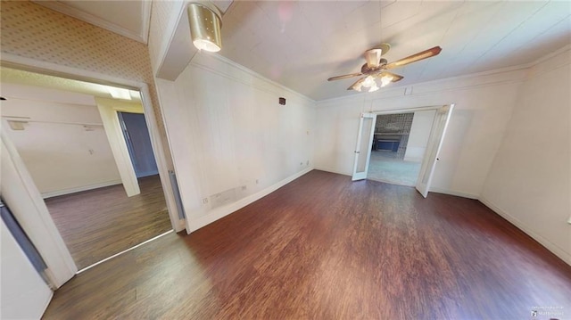 unfurnished room featuring crown molding, ceiling fan, and dark wood-type flooring