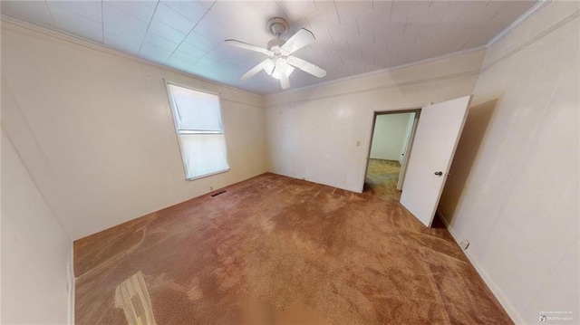 carpeted empty room with ceiling fan and ornamental molding