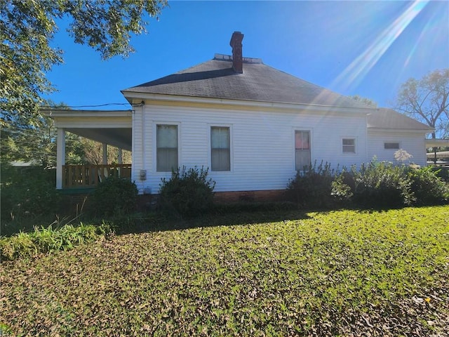 back of property featuring a lawn