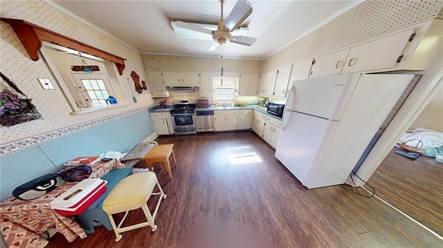 kitchen with crown molding, white cabinetry, dark wood-type flooring, and stainless steel appliances