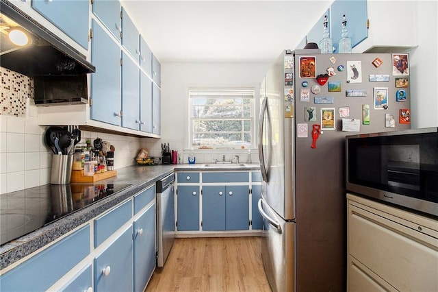 3055 Henderson Mill Rd, Atlanta, GA 30341 - kitchen featuring blue cabinets, appliances with stainless steel finishes, a sink, and backsplash