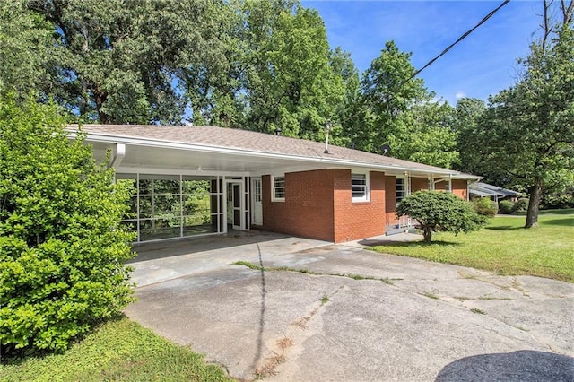 3055 Henderson Mill Rd, Atlanta, GA 30341 - rear view of property with brick siding, a lawn, driveway, and an attached carport