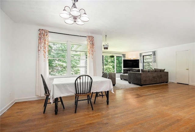 3055 Henderson Mill Rd, Atlanta, GA 30341 - dining area featuring a chandelier, wood finished floors, and baseboards