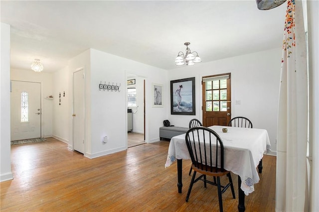 3055 Henderson Mill Rd, Atlanta, GA 30341 - dining area featuring a chandelier, light wood-type flooring, and baseboards
