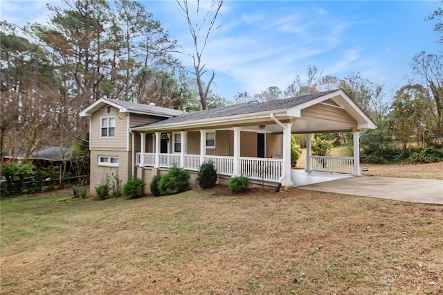 view of front of property with a carport, a porch, and a front lawn