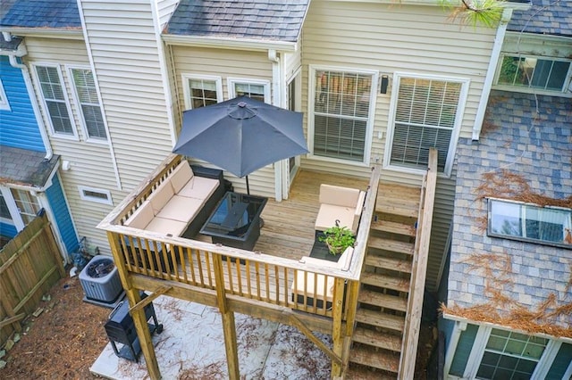 wooden deck featuring central AC unit