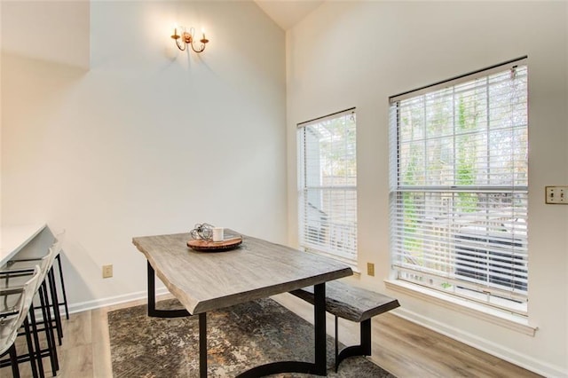 dining room featuring lofted ceiling and light wood-type flooring