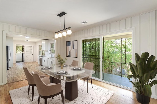 201 E Simon Ter NW, Atlanta, GA 30318 - dining room with light wood-style floors and a decorative wall