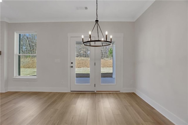 entryway with a chandelier and light wood-type flooring