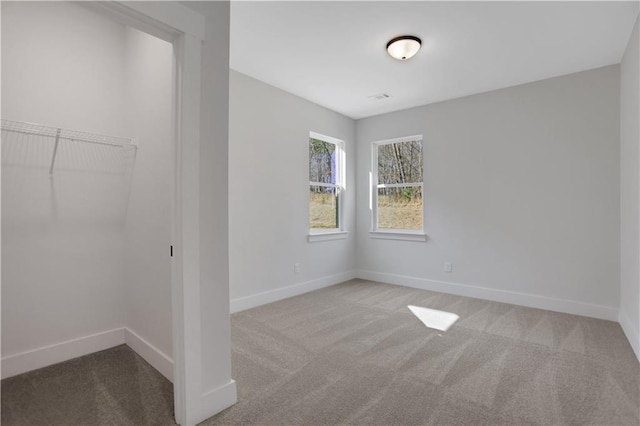 unfurnished room featuring light carpet