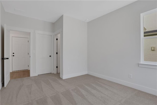 carpeted spare room featuring a wealth of natural light