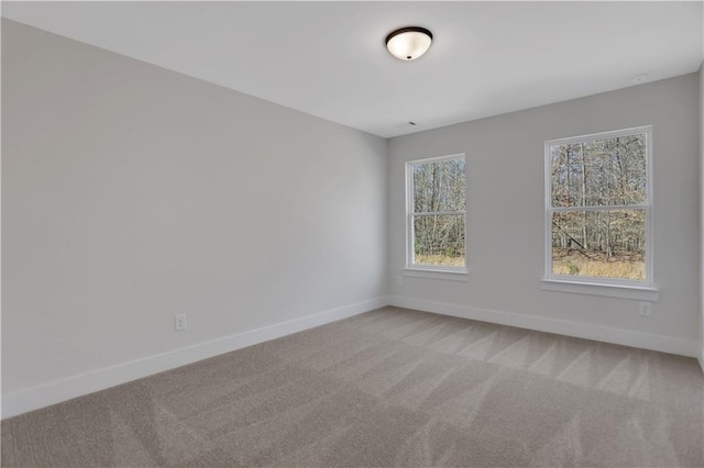 carpeted spare room with plenty of natural light