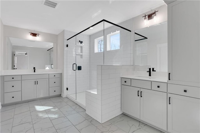 bathroom with a shower with shower door and vanity