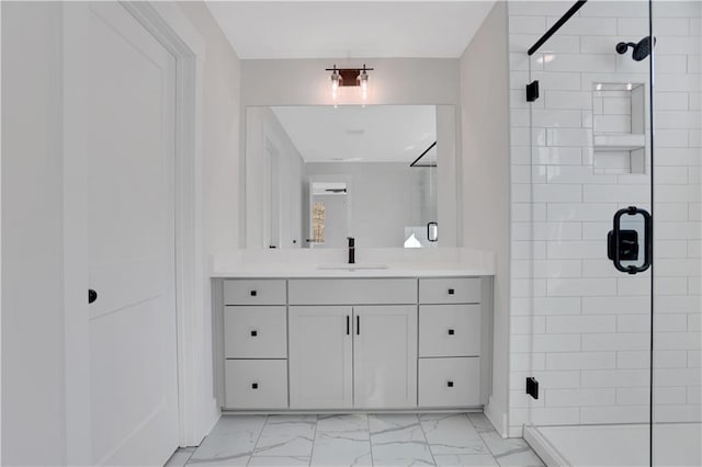 bathroom with a shower with shower door and vanity