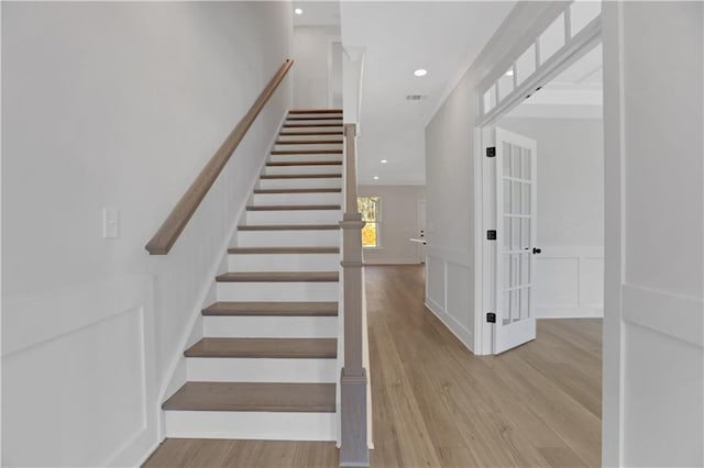 stairs with hardwood / wood-style floors