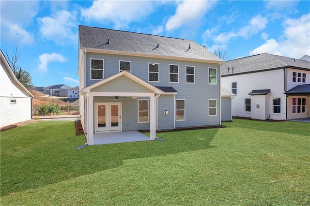 back of house with ceiling fan, a patio, french doors, and a lawn