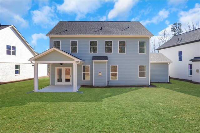 back of property featuring a lawn and a patio area