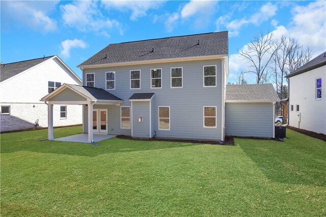 rear view of house with a yard and a patio area