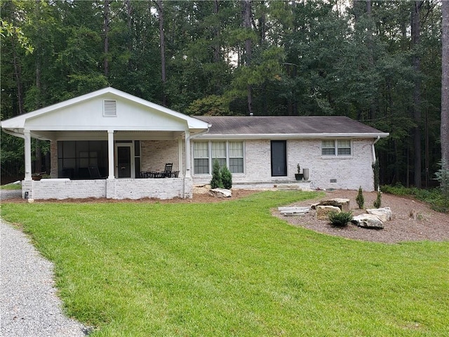 ranch-style home with covered porch and a front lawn