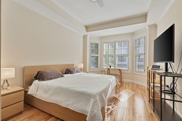 bedroom featuring ceiling fan, crown molding, and light wood-type flooring