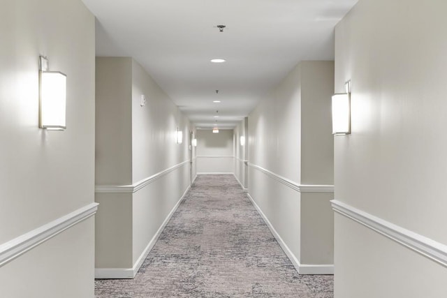 corridor featuring light colored carpet