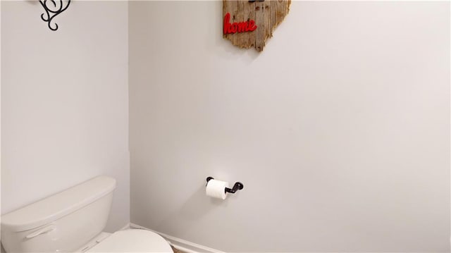 bathroom with toilet and baseboards