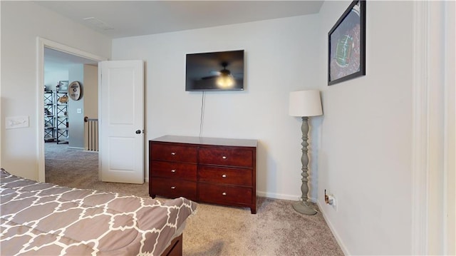 carpeted bedroom featuring baseboards