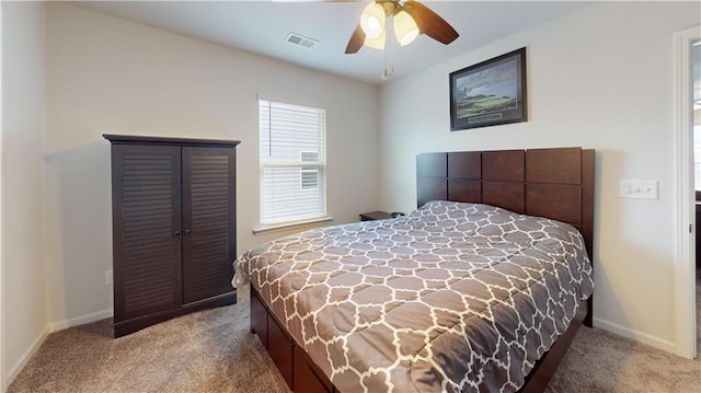 carpeted bedroom featuring ceiling fan, visible vents, and baseboards