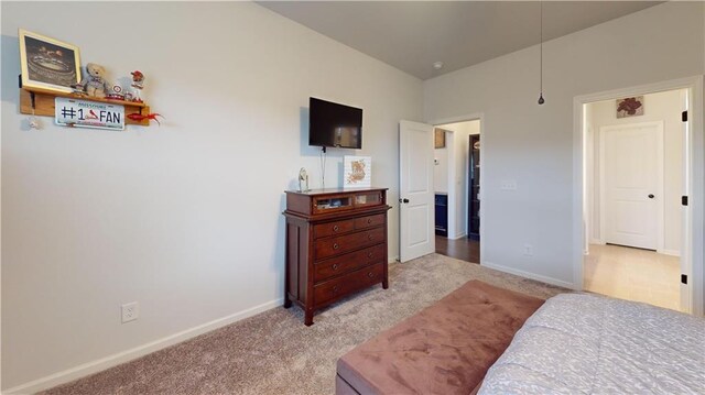 bedroom featuring baseboards, a ceiling fan, and light colored carpet