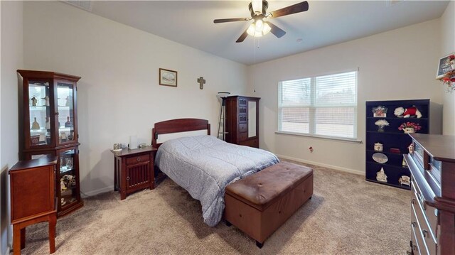 bedroom with light carpet, baseboards, visible vents, and ceiling fan