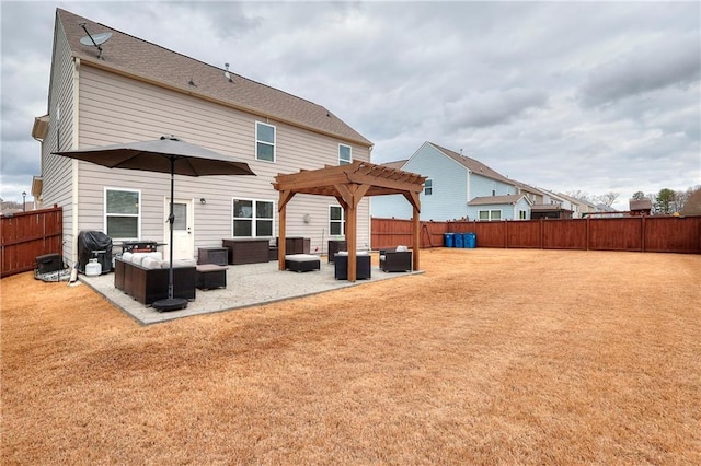 back of house featuring a yard, a fenced backyard, a patio, and a pergola