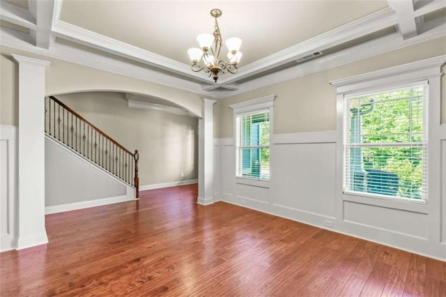 spare room featuring coffered ceiling, dark wood-style floors, a wainscoted wall, stairs, and beam ceiling