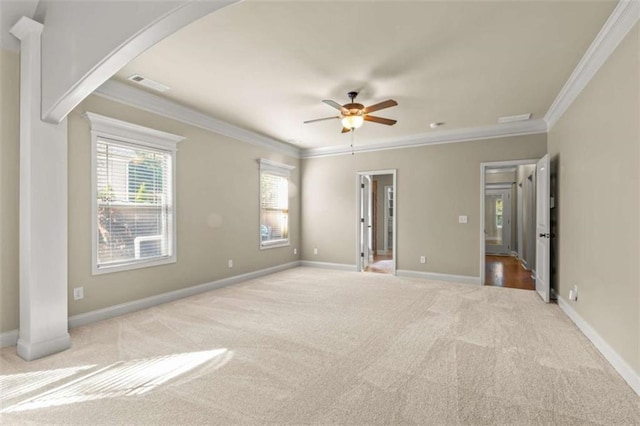 unfurnished room featuring baseboards, a wealth of natural light, visible vents, and light colored carpet