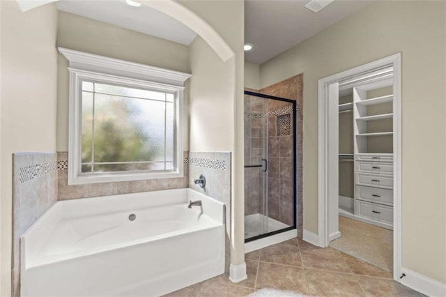 full bathroom with baseboards, a garden tub, tile patterned flooring, a spacious closet, and a shower stall