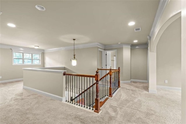 hall with light carpet, an upstairs landing, and crown molding