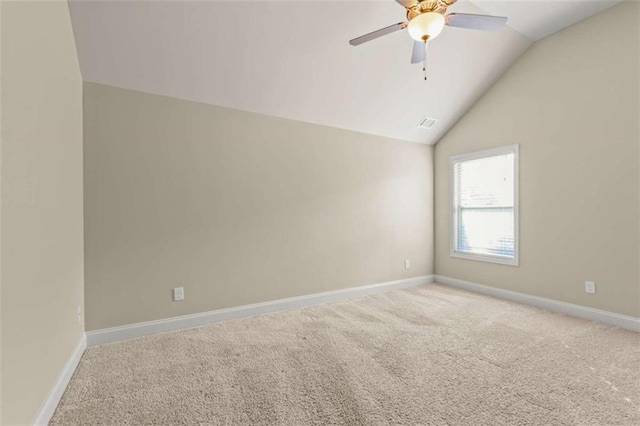 empty room with a ceiling fan, visible vents, vaulted ceiling, baseboards, and carpet