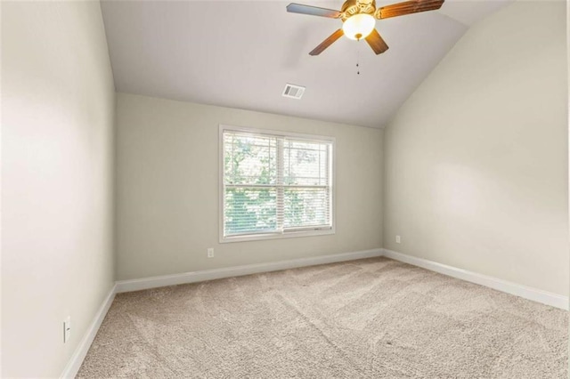 unfurnished room featuring vaulted ceiling, carpet floors, visible vents, and baseboards