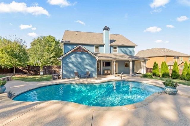 view of pool with a fenced in pool, a patio area, and fence