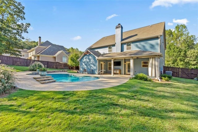 back of house with a fenced in pool, a patio area, a yard, and a fenced backyard