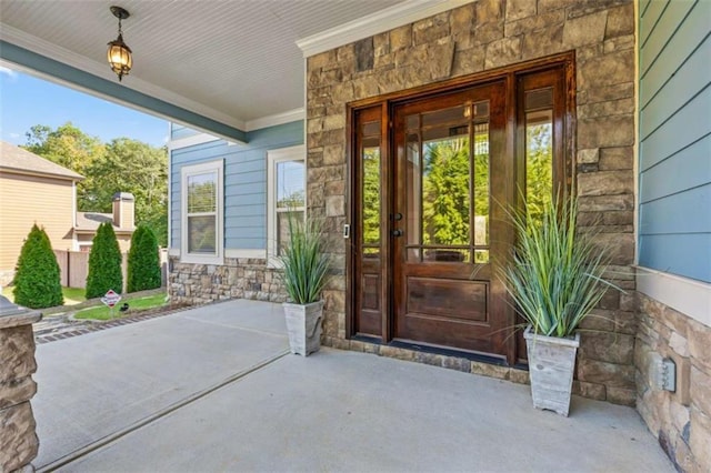 view of exterior entry featuring stone siding