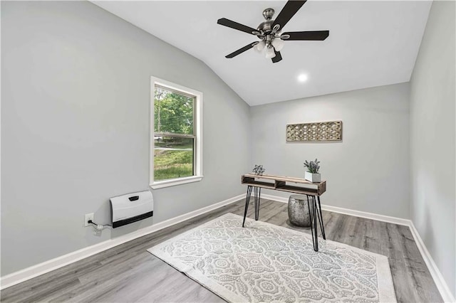 office with heating unit, hardwood / wood-style floors, vaulted ceiling, and ceiling fan