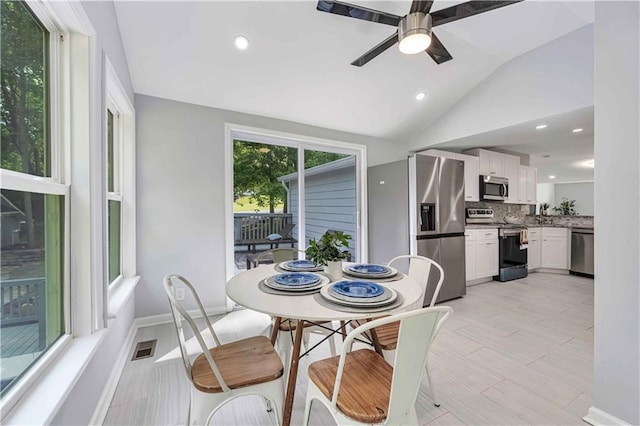 dining area featuring lofted ceiling and ceiling fan