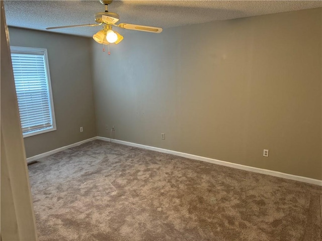 carpeted spare room with ceiling fan and a textured ceiling