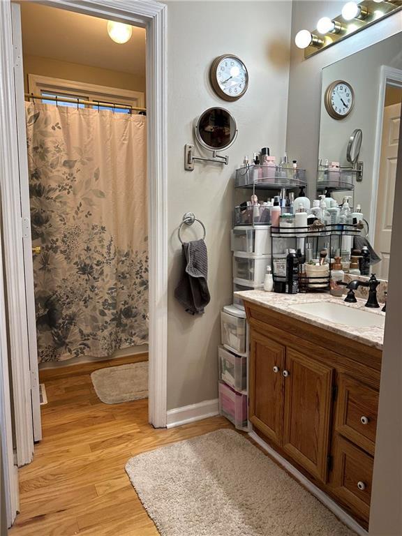 bathroom with vanity, hardwood / wood-style floors, and a shower with shower curtain